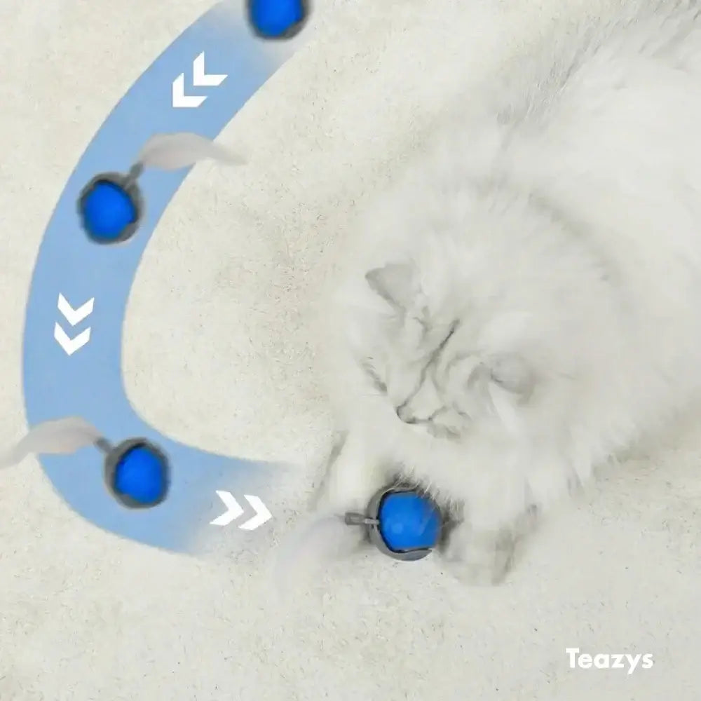 The fluffy white cat eagerly chases the blue SPEEDY TAIL 2.0 ball toy with feathers, highlighted by arrows showing its lively movement.