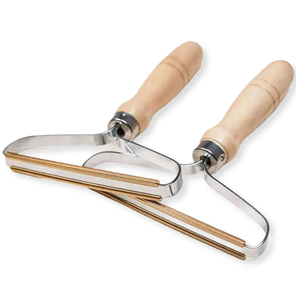 Two POWER BRUSH stainless steel lint removers with wooden handles are placed overlapping each other on a white background.